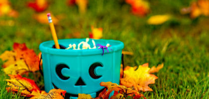 A blue Halloween bucket filled with goodies