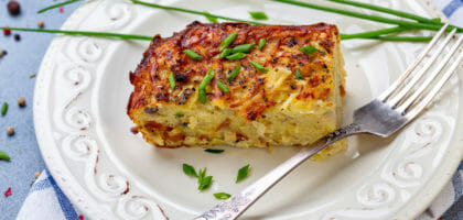 Piece of potato kugel on a plate.