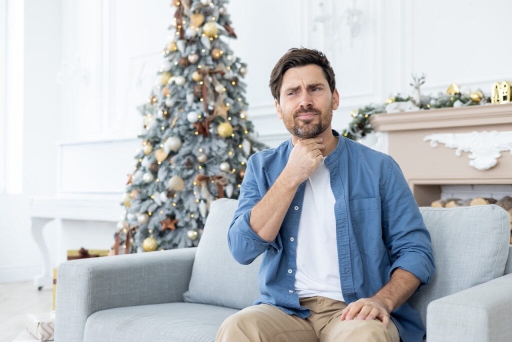 Modern living room decorated with allergy-friendly holiday decorations and artificial tree