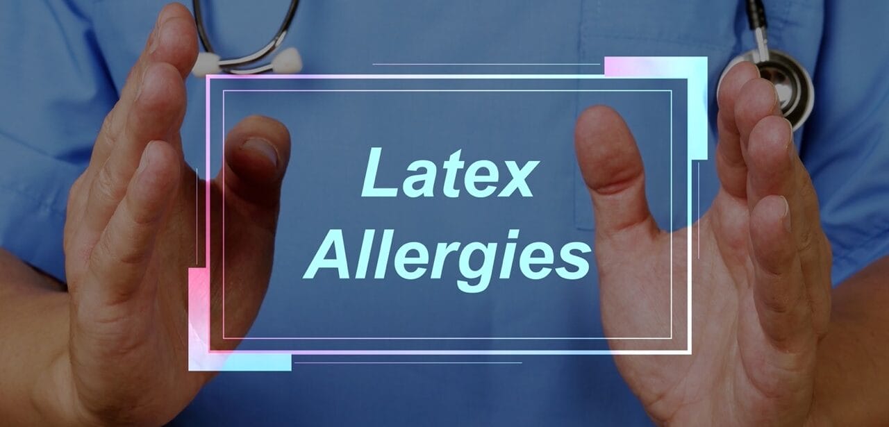 Healthcare professional showing latex allergy warning sign against blue scrubs background