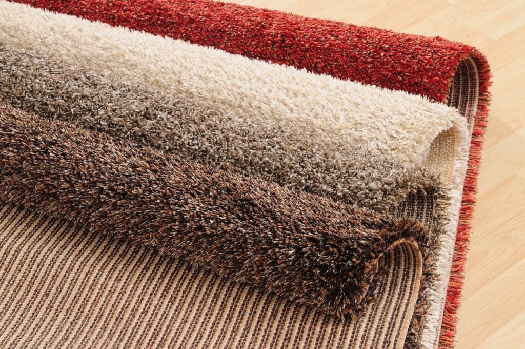 Rolled carpets showing latex-free alternatives in various colors and textures