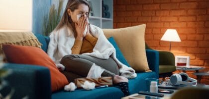 Sneezing indoors with winter allergy symptoms